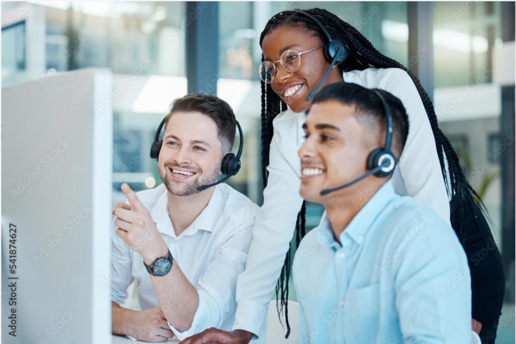 Anika Tannebaum—Europe’s No. 1 service expert—inspires a team of three customer service representatives wearing headsets, who are smiling together in front of a monitor